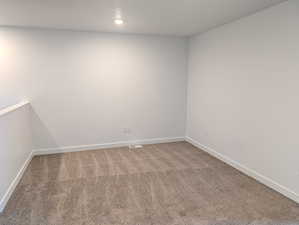 Unfurnished room with baseboards and carpet flooring