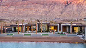 Back of property with a patio and a water and mountain view