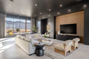 Tiled living area with recessed lighting and expansive windows