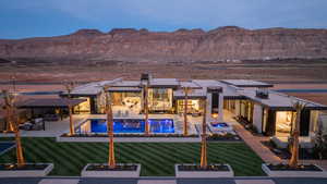 Back of house with an outdoor living space, a patio, a mountain view, and an outdoor pool