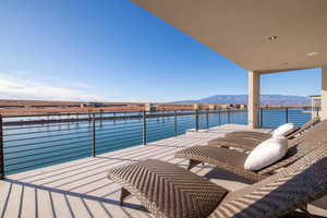 Balcony with a water and mountain view