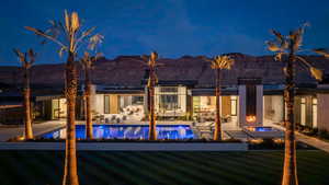 Swimming pool with a patio area, a mountain view, and an in-ground hot tub