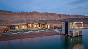 Rear view of house with a water and mountain view and a patio area