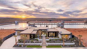 View of property at dusk