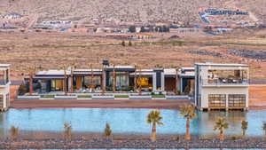 Rear view of house featuring a water view and a patio area