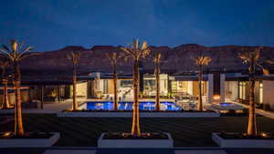 Rear view of house featuring a patio area, a mountain view, a fire pit, and an outdoor pool