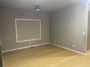 Empty room featuring light wood-type flooring and baseboards