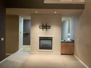 Living room featuring a fireplace, light carpet, and recessed lighting