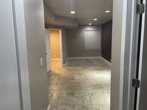 Spare room with stone tile flooring and recessed lighting