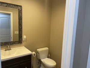 Half bath featuring vanity and toilet