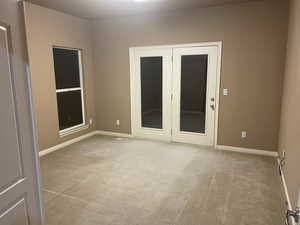 Unfurnished room with light carpet and baseboards