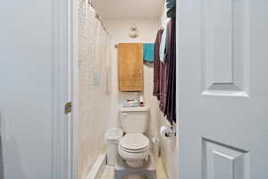 Full bathroom with a shower with shower curtain and tile patterned floors
