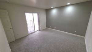 Empty room featuring recessed lighting and carpet flooring