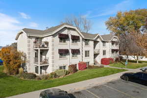 View of property featuring uncovered parking