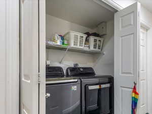 Washroom featuring carpet floors and washer and clothes dryer
