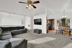 Living room with a chandelier, light carpet, and a ceiling fan