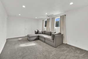 Living area with carpet and recessed lighting