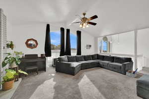 Living room featuring healthy amount of natural light, carpet floors, and ceiling fan