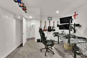 Home office with light carpet and recessed lighting