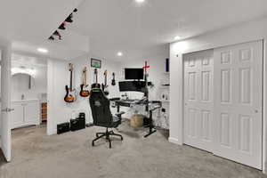 Office featuring light colored carpet, a textured ceiling, and recessed lighting