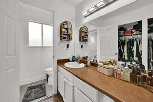 Full bath featuring vanity and a spacious closet