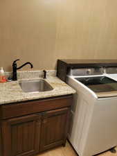 Laundry room featuring washer / dryer and cabinet space