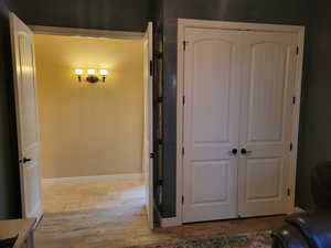 Interior space featuring a closet and stone tile floors