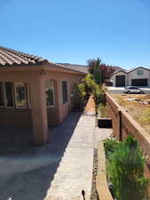 View of property exterior featuring stucco siding and a tiled roof