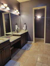 Bathroom featuring stone tile floors and vanity