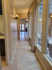 Hallway featuring arched walkways and stone tile floors