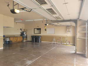 Garage with water heater and a garage door opener