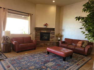 Living area featuring a fireplace, recessed lighting, and tile patterned floors