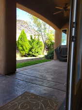 View of patio with ceiling fan, grilling area, and a mountain view
