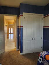 Tiled bedroom featuring carpet floors, a closet, french doors, and arched walkways