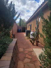 View of side of property with a gate and stucco siding