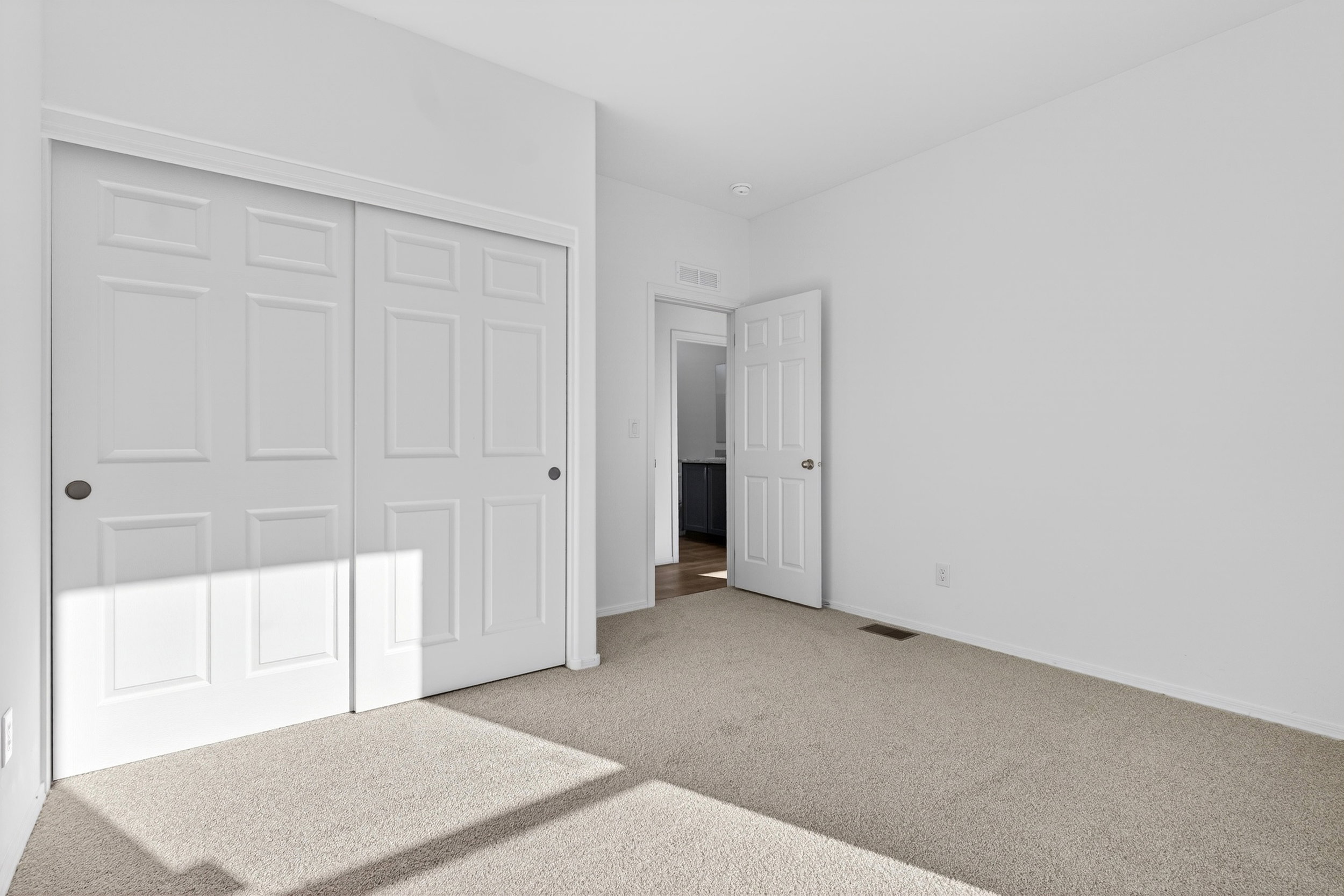 Unfurnished bedroom featuring carpet flooring and a closet