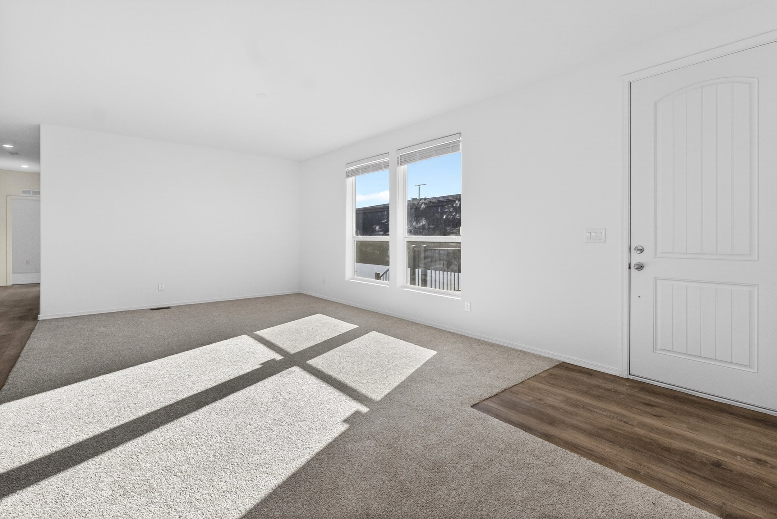 Empty room with dark carpet and baseboards