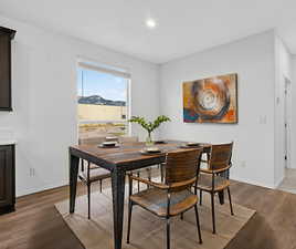 Dining area with wood finished floors and recessed lighting