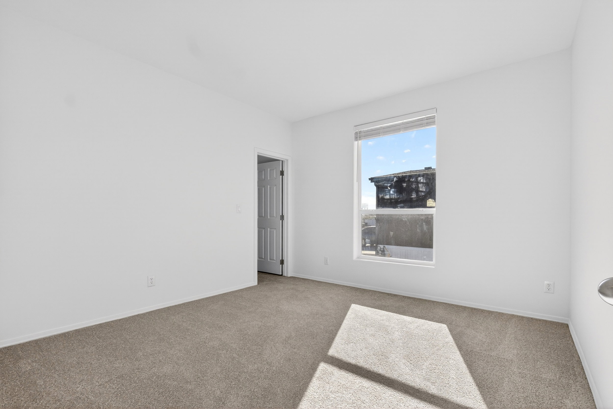 Carpeted spare room with baseboards