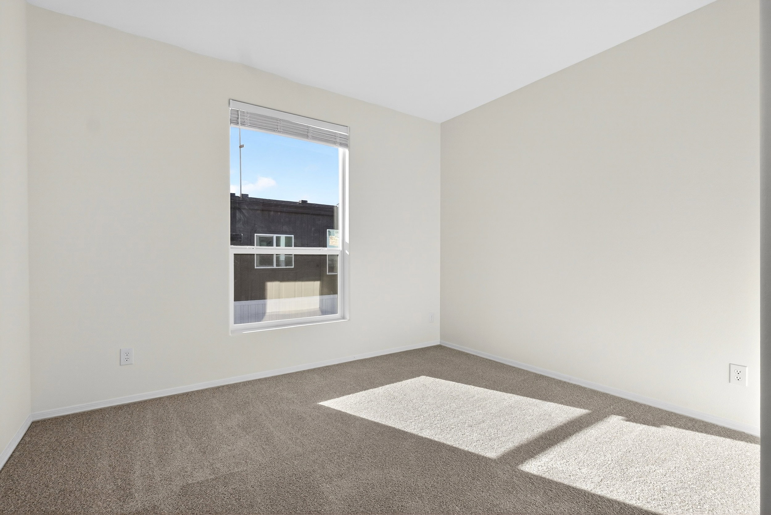 Carpeted empty room featuring baseboards