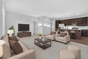 Living room with wood finished floors and recessed lighting