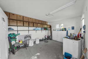 Garage featuring white refrigerator