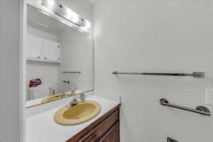 Half bathroom with vanity and toilet