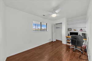 Office space featuring dark wood finished floors and a ceiling fan