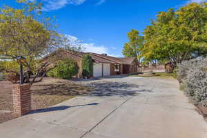 View of front facade featuring driveway and an attached garage