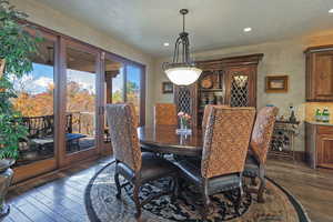 Dining area featuring dark wood-style floors and recessed lighting