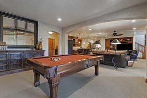Playroom featuring arched walkways, light colored carpet, ceiling fan, recessed lighting, and billiards