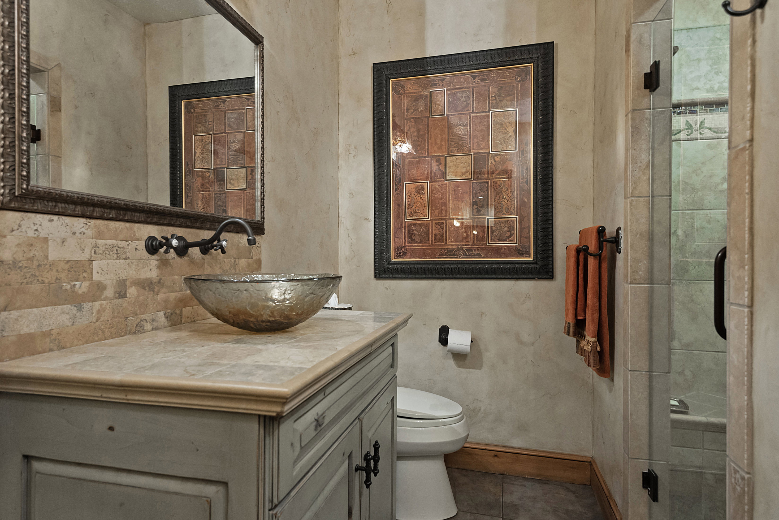 Full bath with vanity, a stall shower, and dark tile patterned floors