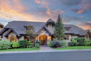 Tudor house with stucco siding, stone siding, and a yard