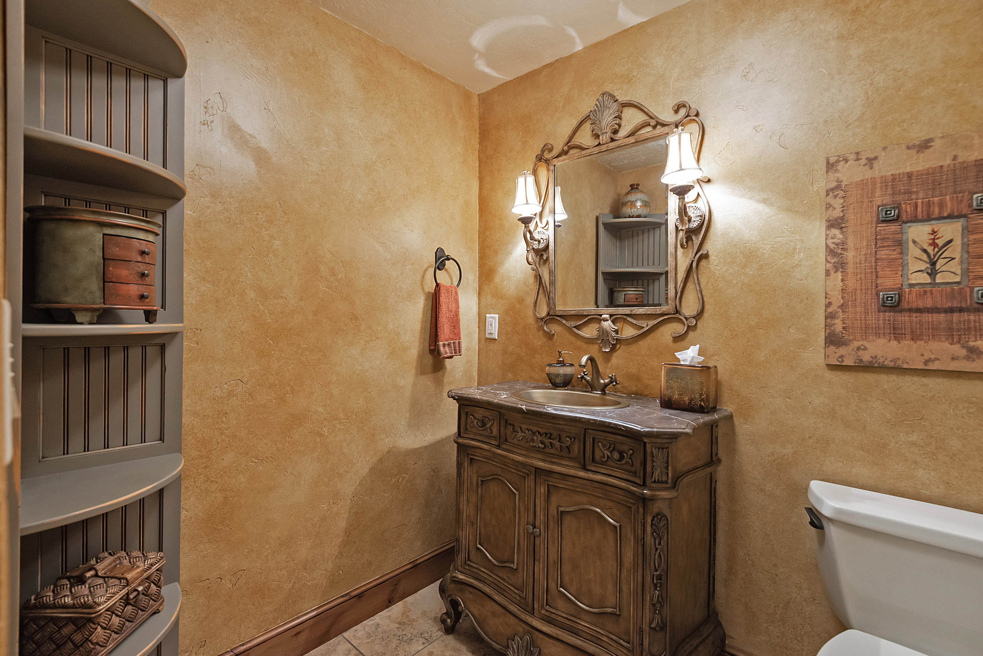 Bathroom with vanity, a textured wall, and light tile patterned floors
